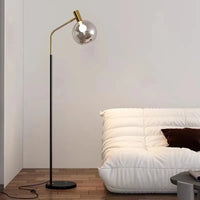 Elegante Stehleuchte in Gold und Schwarz aus Metall und Glas