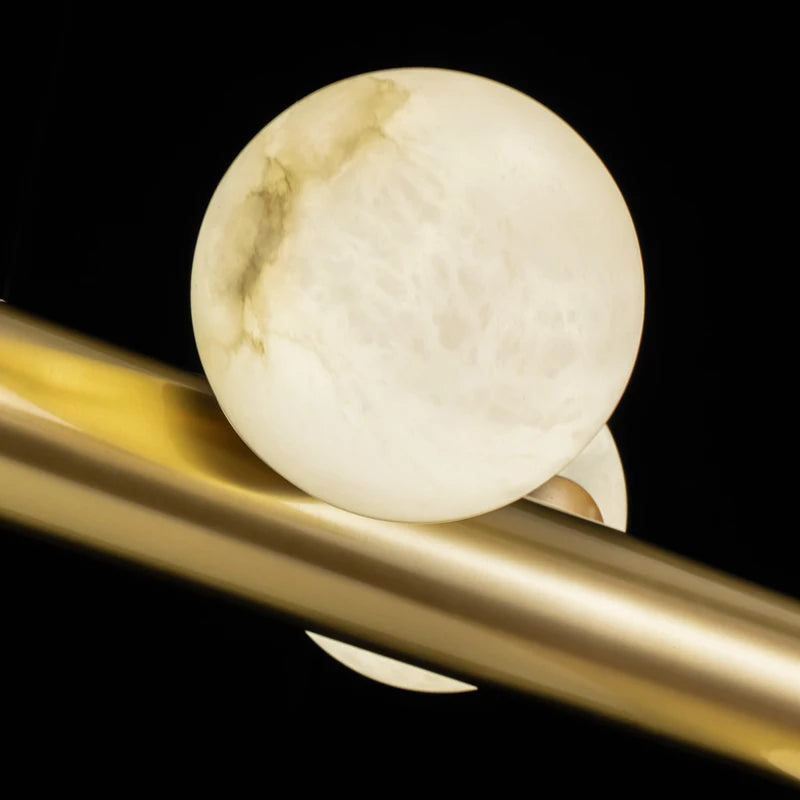 barre avec boule suspension table ronde en marbre éclairage salon de thé