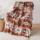 plaid tricoté bohème motifs géométriques avec pompons doux
