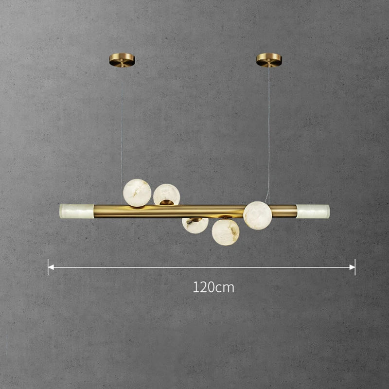 barre avec boule suspension table ronde en marbre éclairage salon de thé