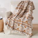 plaid tricoté bohème motifs géométriques avec pompons doux
