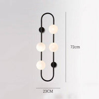 Design-Wandleuchte LED mit Metallring und Glaskugel