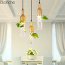 LED-Pendelleuchte aus Holz mit Pflanze und integriertem Wassertank Bottle
