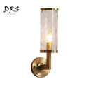 Goldene Wandleuchte mit zylindrischem Glasschirm